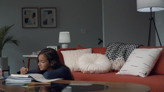 Child on couch doing homework