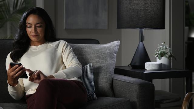 Woman using phone on couch