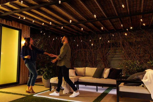 Couple dancing on patio with light strips and strip lights
